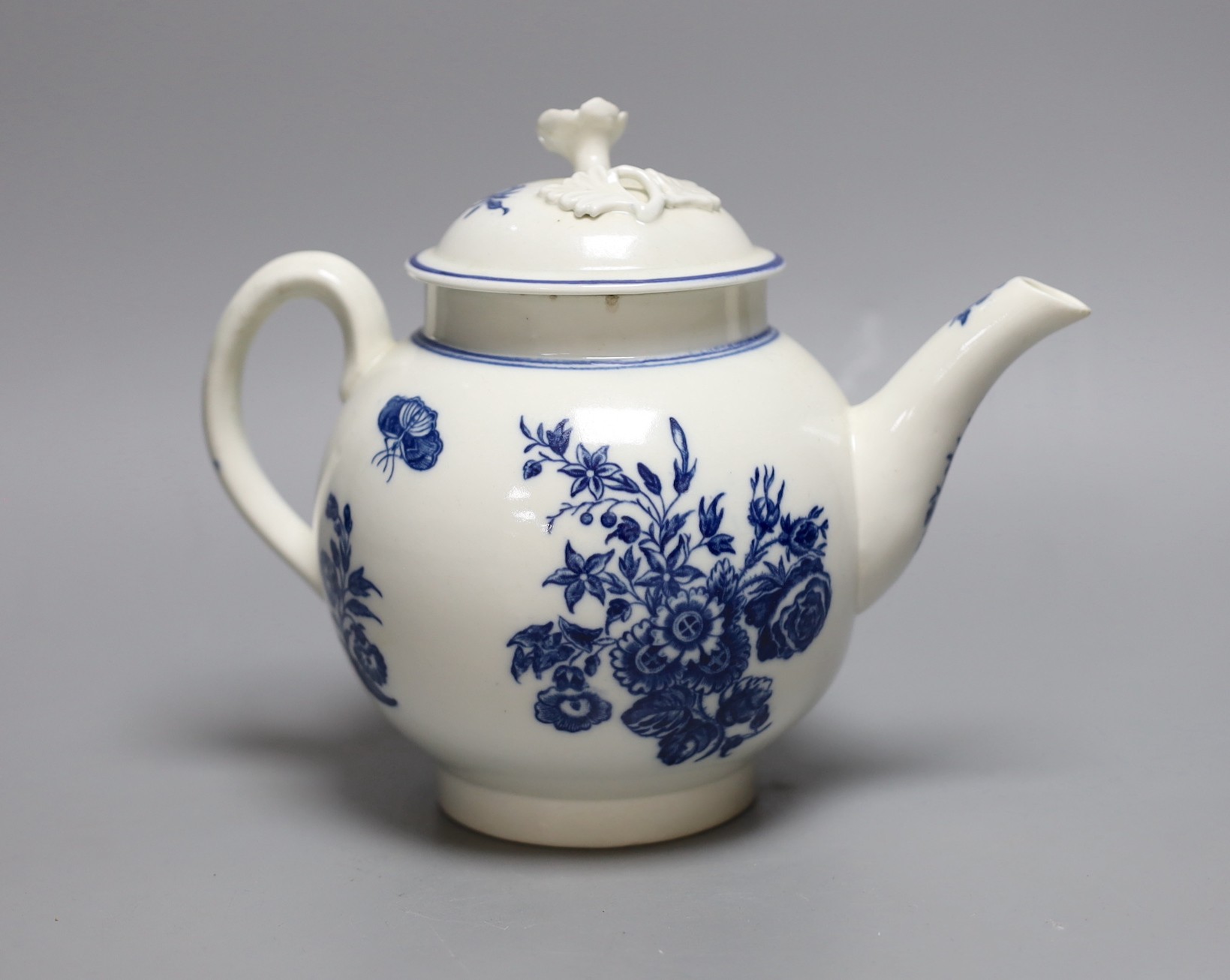 A Caughley teapot and cover printed in underglaze blue with the Three Flowers pattern, S mark in blue to base, 17 cms high